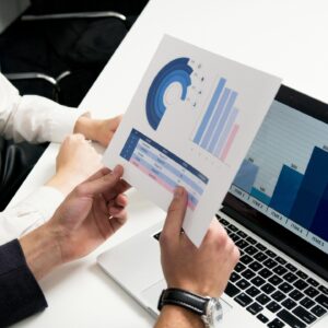 Business professionals discussing data charts and graphs in a modern office setting.